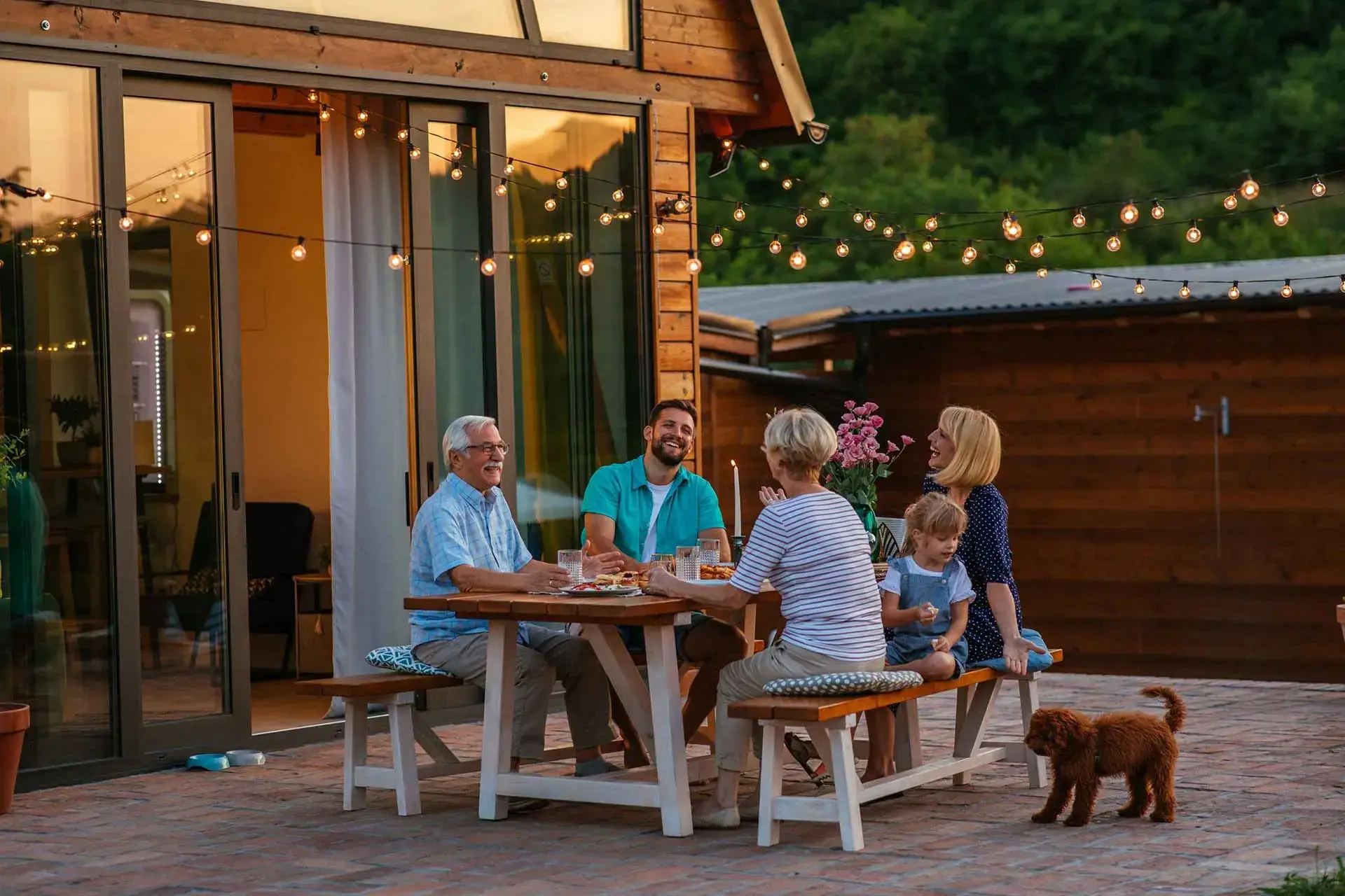 Family gathering outdoors with dog.